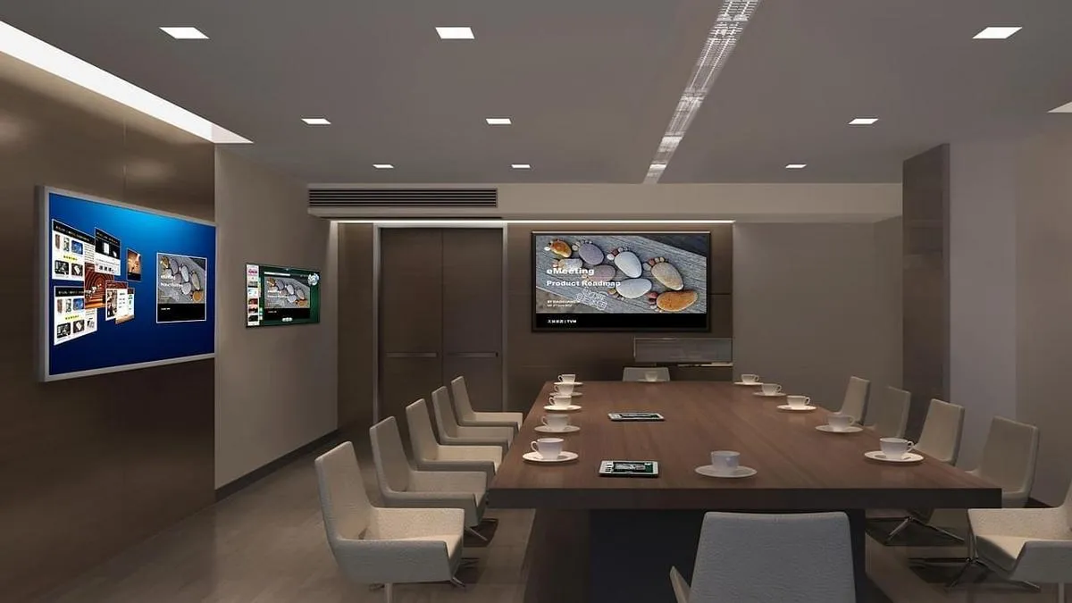 Digital signs on a conference room wall controlled by digital signage content management software.
