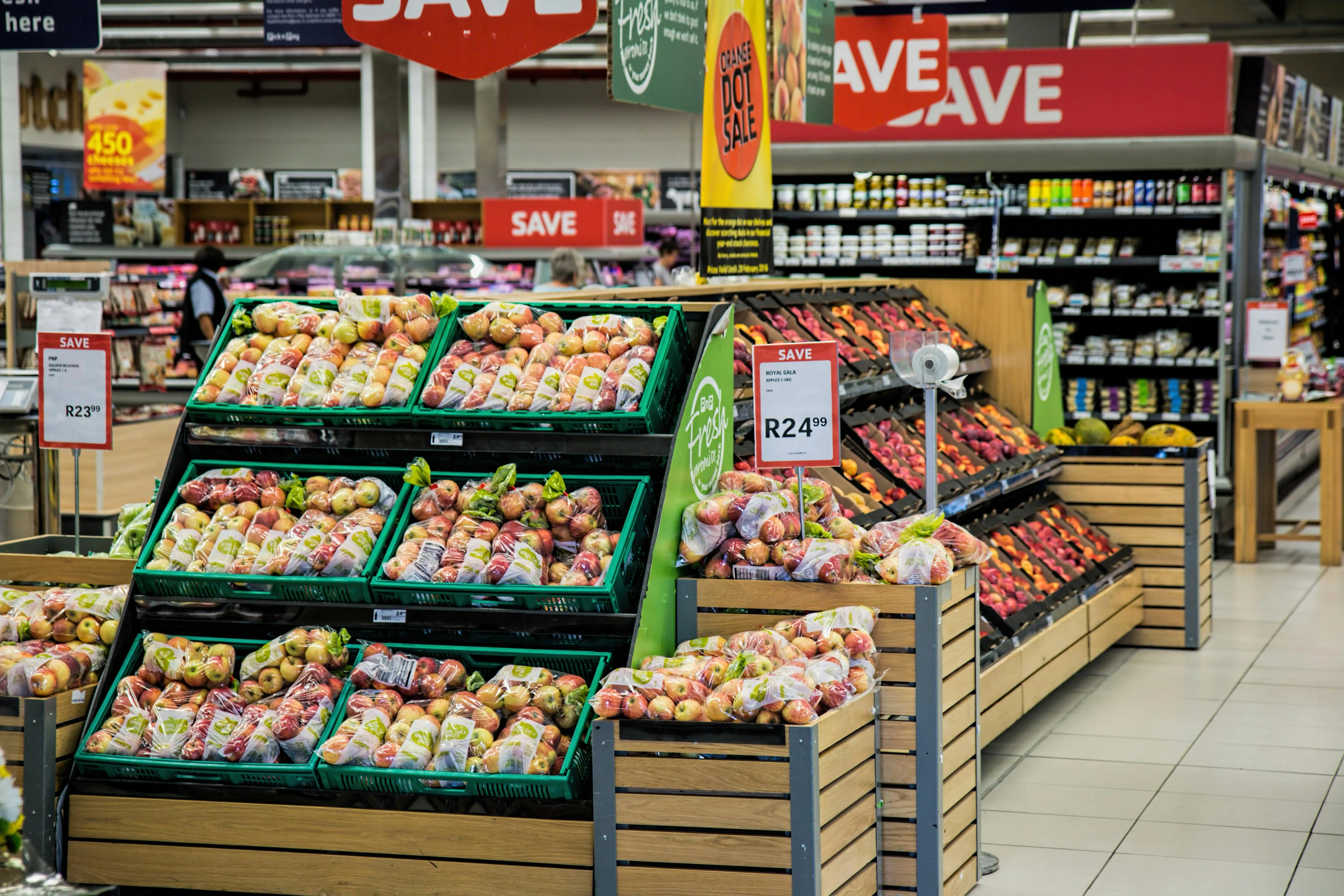 A modern supermarket with a view of the fruit section.