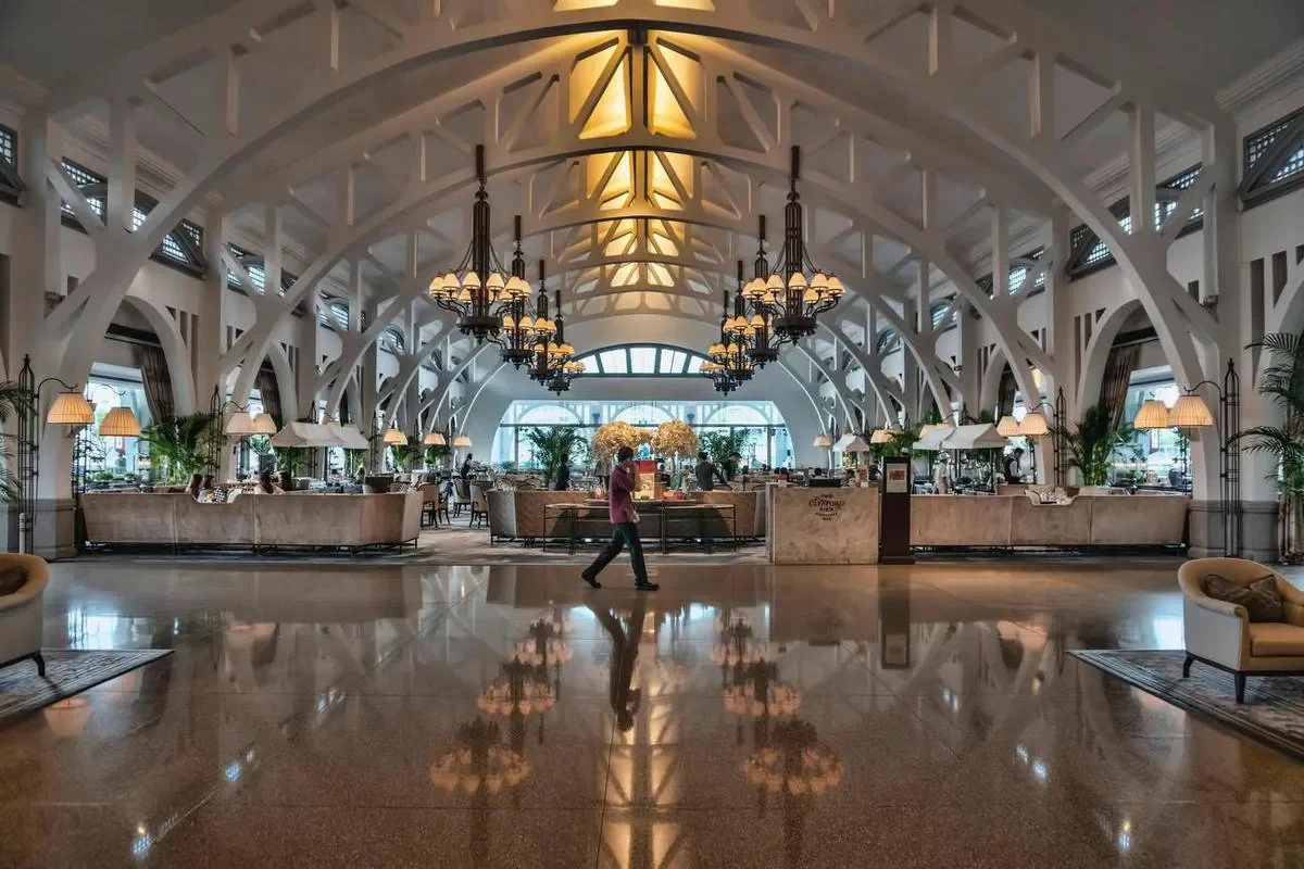 A grand hotel lobby with a digital sign, the kind of space hotel digital signage serves.