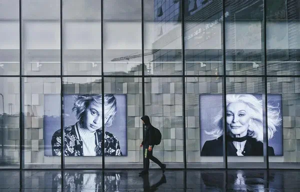 Two digital advertising screens in a lobby that are part of a digital signage advertising network.