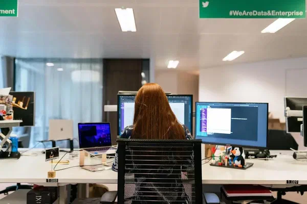 A woman using digital signage content management software.