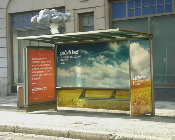 A digital signage enclosure unit at a bus stop.