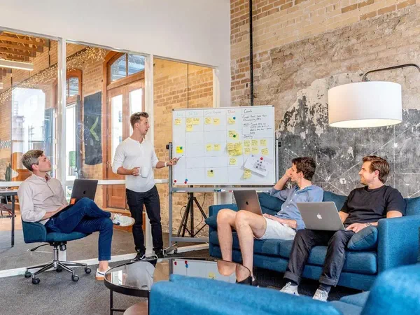 A team in an upscale office working on strategy to achieve product-market fit.