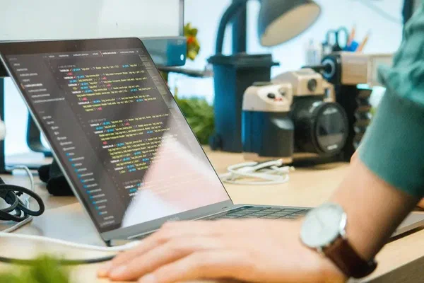 A person updating the code for their programmable digital sign.