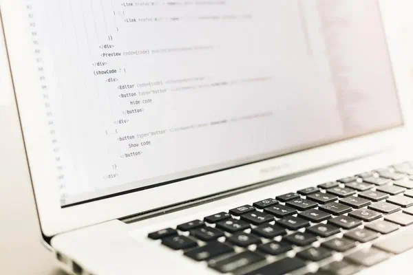 An image of a computer with code and updates from the Screenly team.