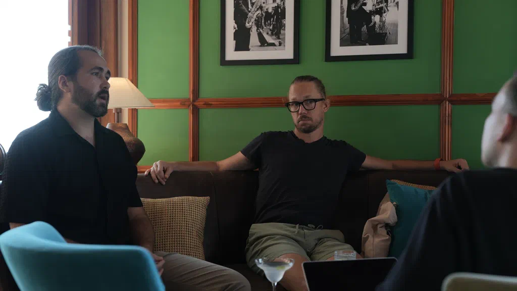Screenly team members chatting in a hotel lounge