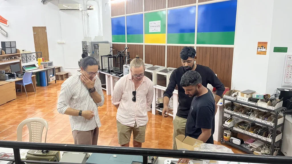 Viktor and Renat looking at a project at Fablab Kerala