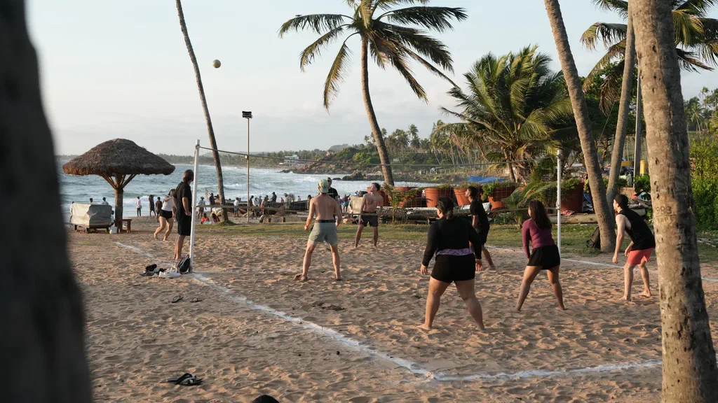 The Screenly team playing beach volleyball on Kovalam Beach
