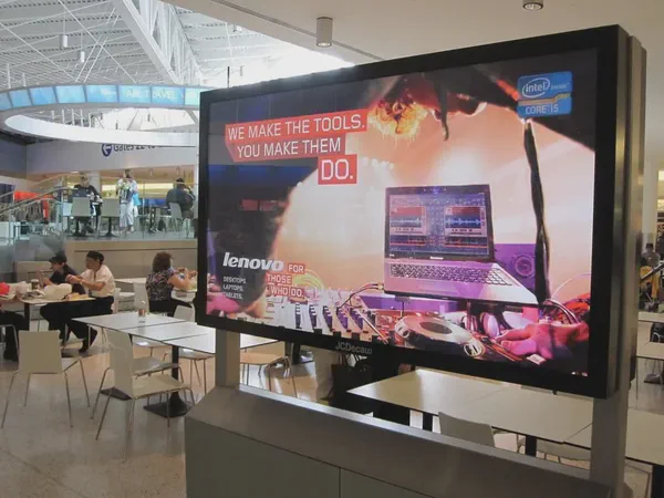 A VESA mounted digital sign in an airport food court.