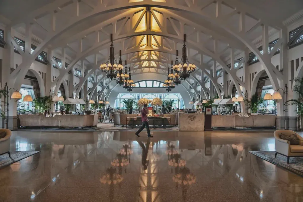 A large hotel lobby with digital lobby signage.