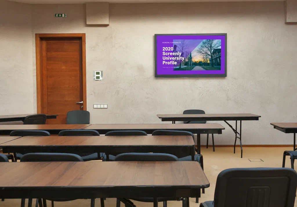 Digital sign in a classroom showing a university profile